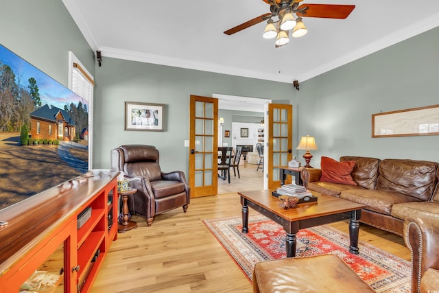 living room featuring french doors, ceiling fan, ornamental molding, and light hardwood / wood-style flooring