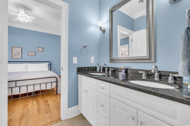 bathroom with crown molding, tile patterned floors, vanity, and ceiling fan