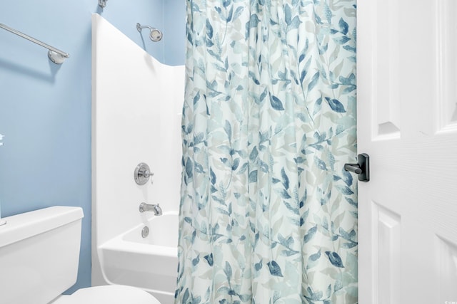 bathroom featuring shower / bathtub combination with curtain and toilet