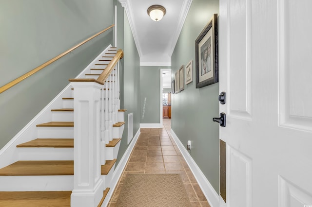 stairs with crown molding and tile patterned flooring