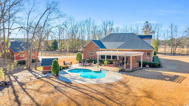 view of pool with a pergola, a patio area, and a lawn