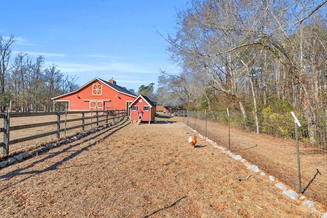 view of yard with a rural view and an outbuilding