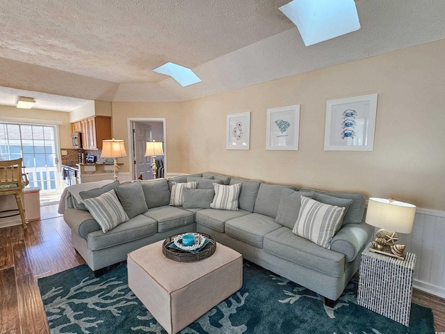 299 Lake Arrowhead Rd, Myrtle Beach, SC 29572 - living room featuring a skylight, a textured ceiling, and dark wood-style flooring