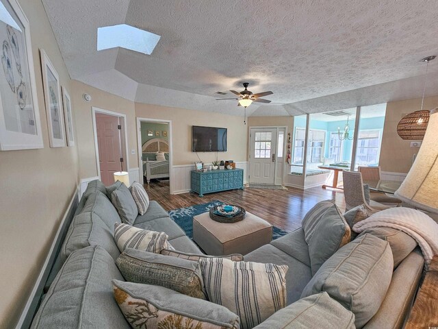299 Lake Arrowhead Rd, Myrtle Beach, SC 29572 - living room with a textured ceiling, wood finished floors, a skylight, a ceiling fan, and a chandelier