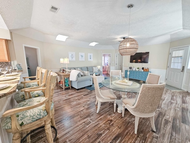 299 Lake Arrowhead Rd, Myrtle Beach, SC 29572 - dining space featuring a textured ceiling, wood finished floors, and wainscoting