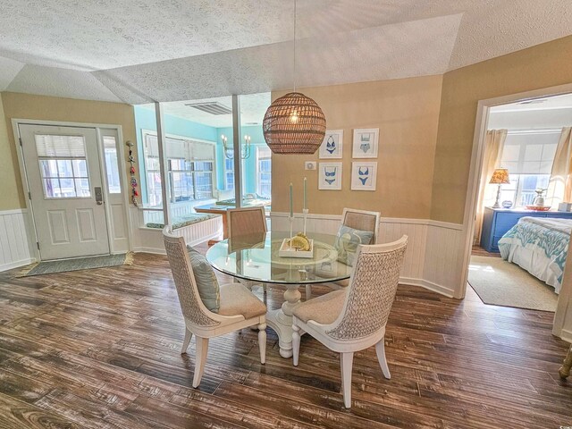 299 Lake Arrowhead Rd, Myrtle Beach, SC 29572 - dining room with a textured ceiling, dark wood-type flooring, wainscoting, and vaulted ceiling