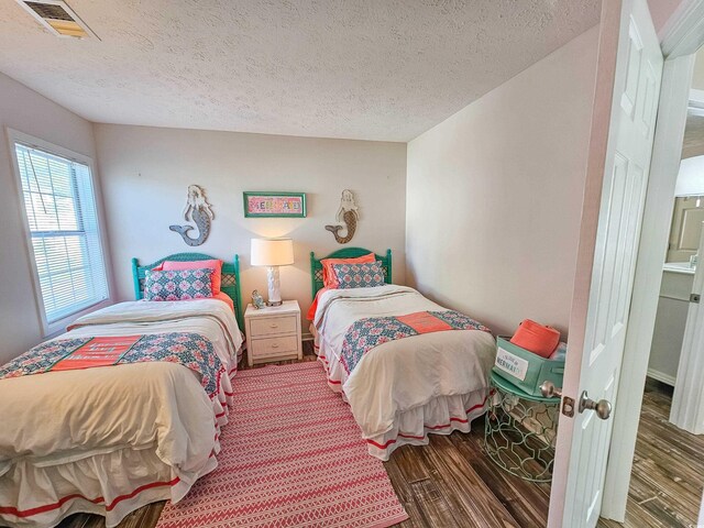 299 Lake Arrowhead Rd, Myrtle Beach, SC 29572 - bedroom with wood finished floors and a textured ceiling