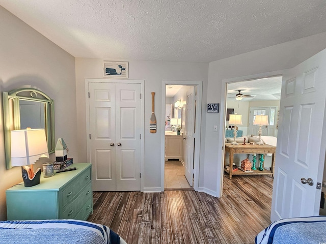 299 Lake Arrowhead Rd, Myrtle Beach, SC 29572 - bedroom featuring dark wood-style flooring, a textured ceiling, a closet, and ensuite bathroom