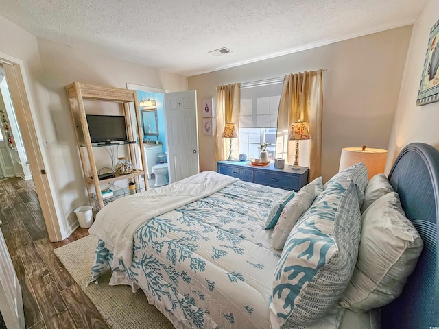 299 Lake Arrowhead Rd, Myrtle Beach, SC 29572 - bedroom with dark wood finished floors, a textured ceiling, and ensuite bathroom