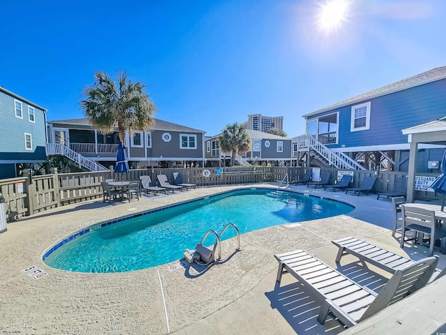 299 Lake Arrowhead Rd, Myrtle Beach, SC 29572 - community pool with stairway, a fenced backyard, and a patio
