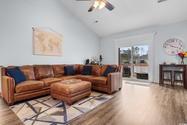 living room with light hardwood / wood-style flooring, high vaulted ceiling, and ceiling fan