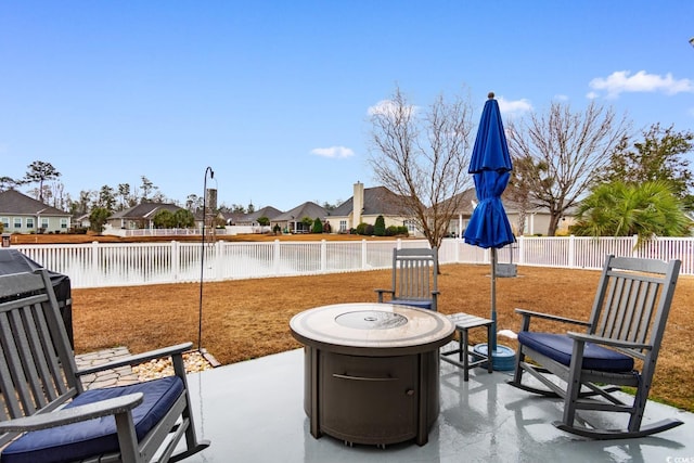 view of patio with a water view and a fire pit