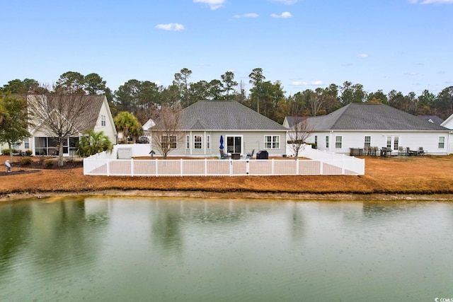 rear view of house featuring a water view