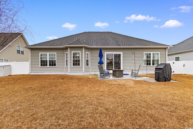 rear view of property with a yard and a patio area