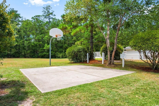 view of basketball court with a yard