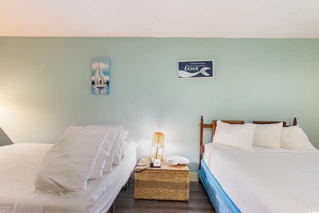 bedroom with dark hardwood / wood-style floors