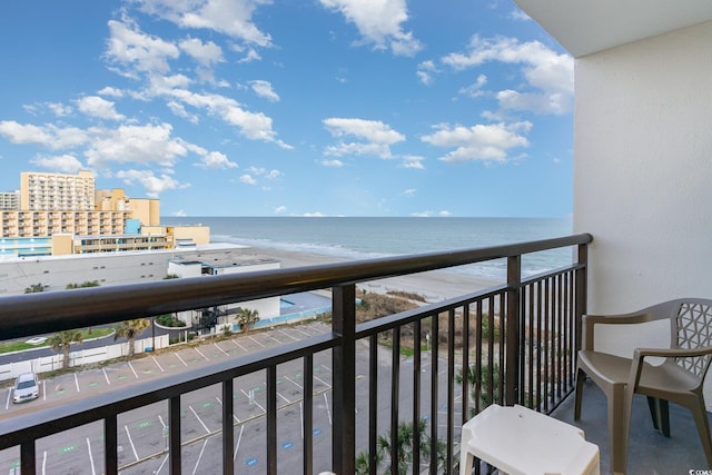 balcony featuring a water view and a view of the beach