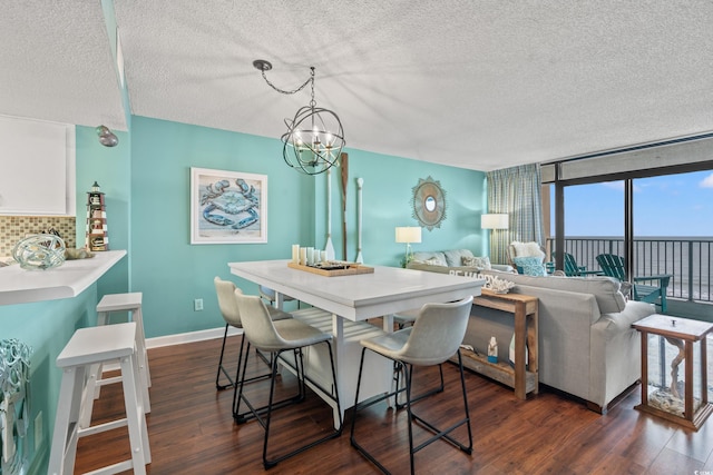 501 S Ocean Blvd Unit 505, North Myrtle Beach, SC 29582 - dining area with a textured ceiling, a chandelier, and dark wood finished floors