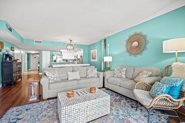 501 S Ocean Blvd Unit 505, North Myrtle Beach, SC 29582 - living area with wood finished floors, a chandelier, and a textured ceiling