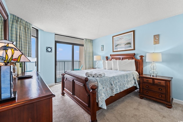 501 S Ocean Blvd Unit 505, North Myrtle Beach, SC 29582 - bedroom featuring access to outside, light carpet, and a textured ceiling