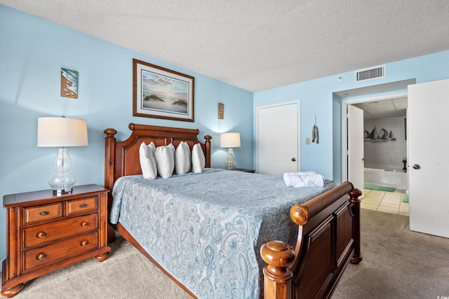 501 S Ocean Blvd Unit 505, North Myrtle Beach, SC 29582 - bedroom featuring light carpet, a textured ceiling, and connected bathroom