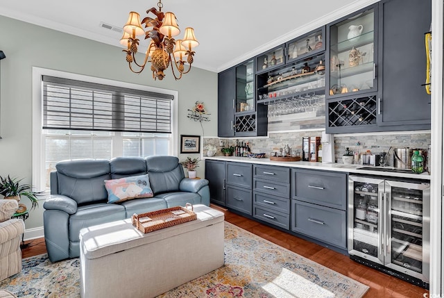 living room with wine cooler, bar, and crown molding