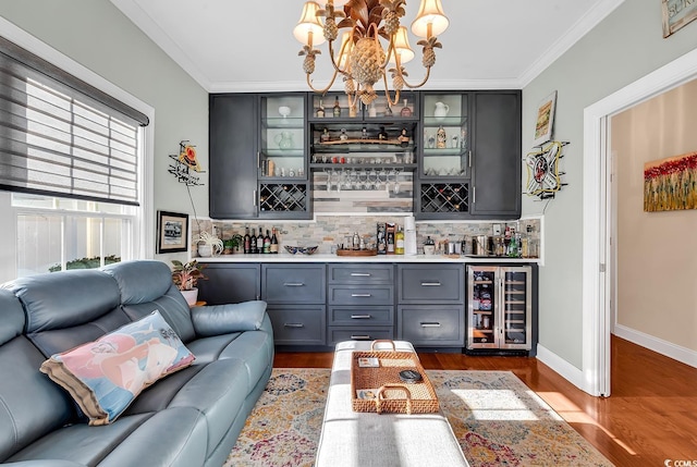 bar featuring wine cooler, dark hardwood / wood-style floors, crown molding, and pendant lighting