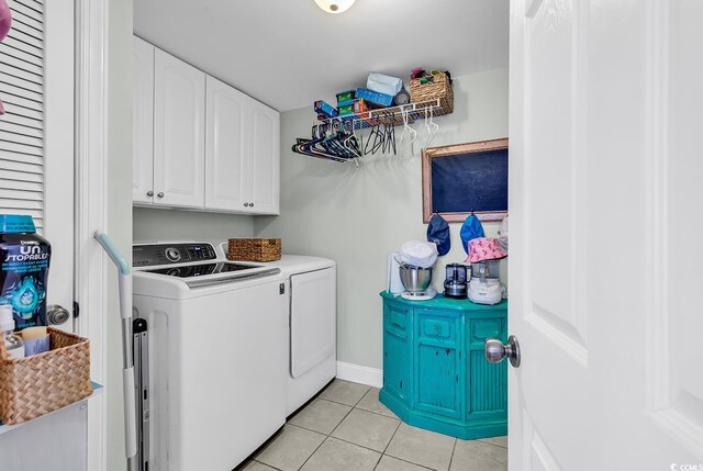 637 Sparrow Dr, Surfside Beach, SC 29575 - laundry room with baseboards, cabinet space, light tile patterned floors, and independent washer and dryer