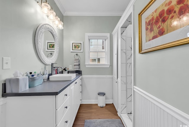 bathroom with ornamental molding, hardwood / wood-style floors, vanity, and walk in shower