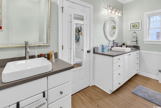 637 Sparrow Dr, Surfside Beach, SC 29575 - bathroom with ornamental molding, a sink, and wood finished floors