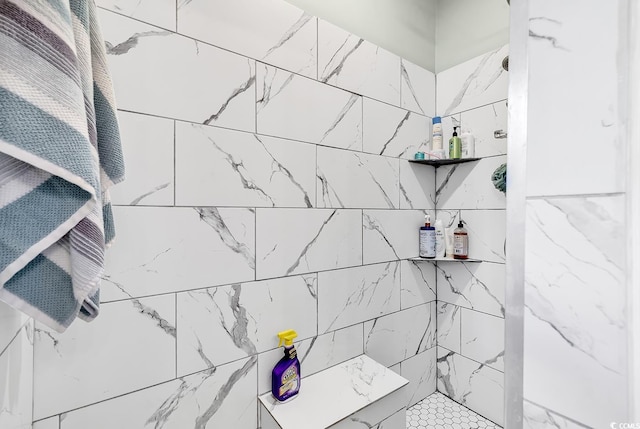 bathroom with tiled shower