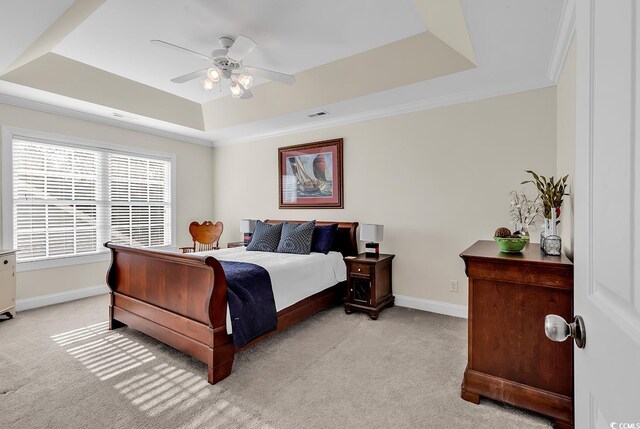 637 Sparrow Dr, Surfside Beach, SC 29575 - bedroom with a tray ceiling, baseboards, ceiling fan, visible vents, and light colored carpet