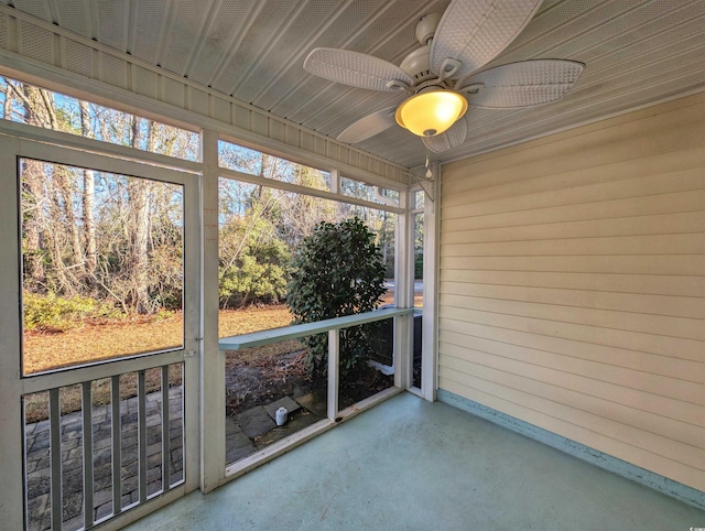 unfurnished sunroom with a ceiling fan