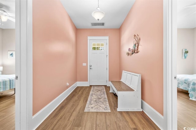 doorway to outside featuring ceiling fan and light wood-type flooring