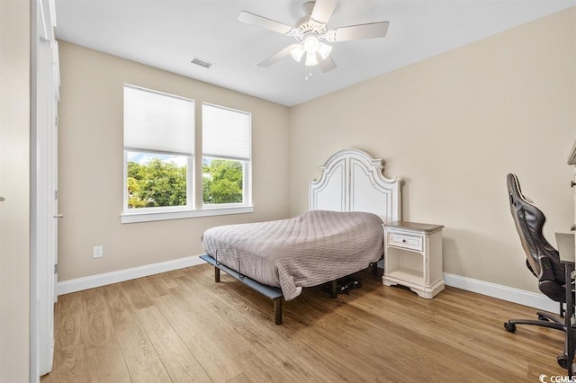 bedroom with ceiling fan and light wood-type flooring