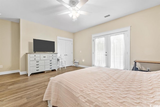 bedroom featuring ceiling fan, access to outside, light hardwood / wood-style floors, and french doors