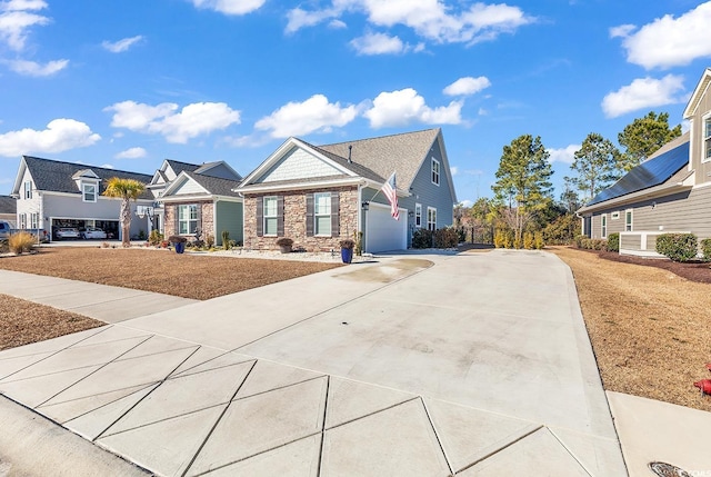 view of front facade featuring driveway, stone siding, and a residential view