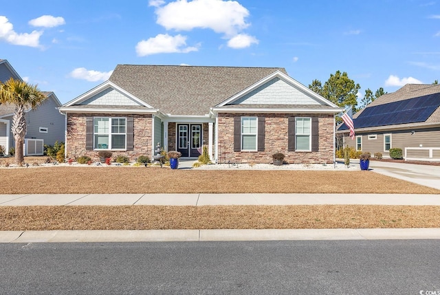 craftsman house featuring stone siding