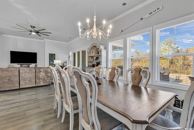 dining area with crown molding, ceiling fan with notable chandelier, and hardwood / wood-style floors