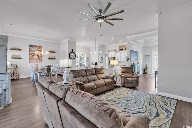 living area featuring a healthy amount of sunlight, baseboards, and wood finished floors