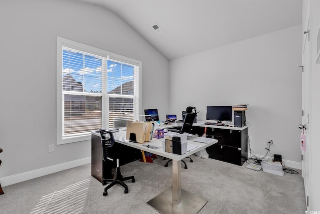 carpeted office space featuring lofted ceiling, visible vents, and baseboards