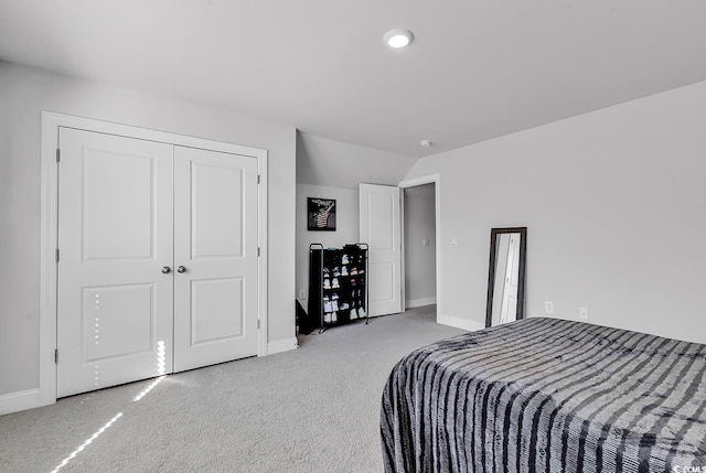 bedroom featuring vaulted ceiling, carpet flooring, and a closet