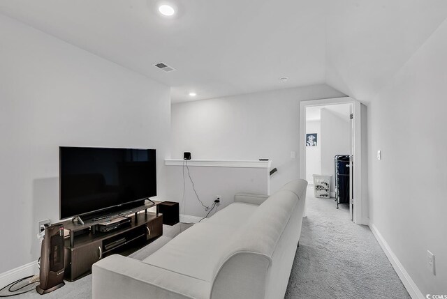 carpeted living room with lofted ceiling