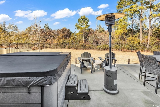 view of patio / terrace featuring a hot tub and a fenced backyard