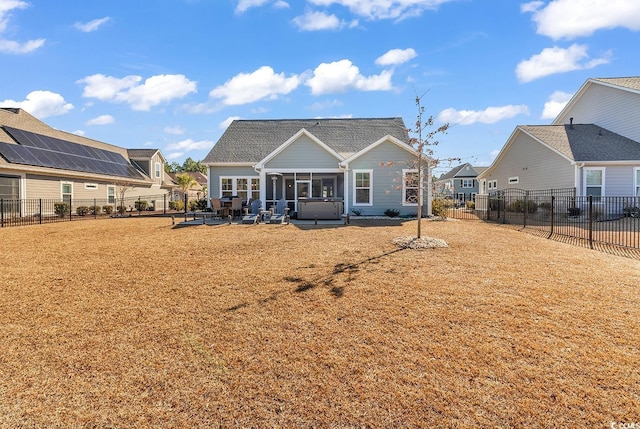 rear view of property with a sunroom, a fenced backyard, a patio, and a yard