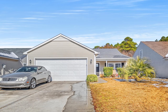 ranch-style home with a garage and a front lawn