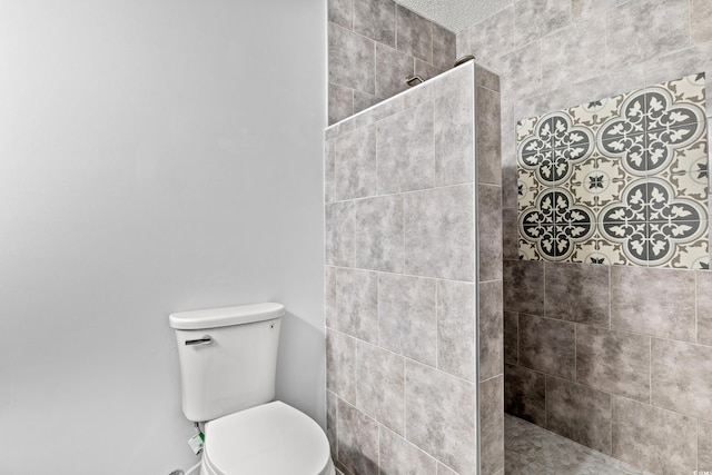 bathroom with tiled shower and toilet