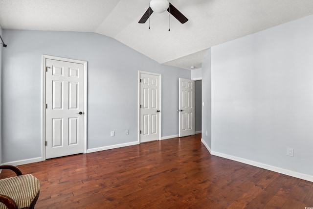 spare room with lofted ceiling, dark hardwood / wood-style floors, and ceiling fan