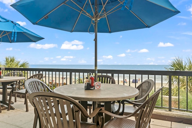 wooden deck featuring a water view and a beach view