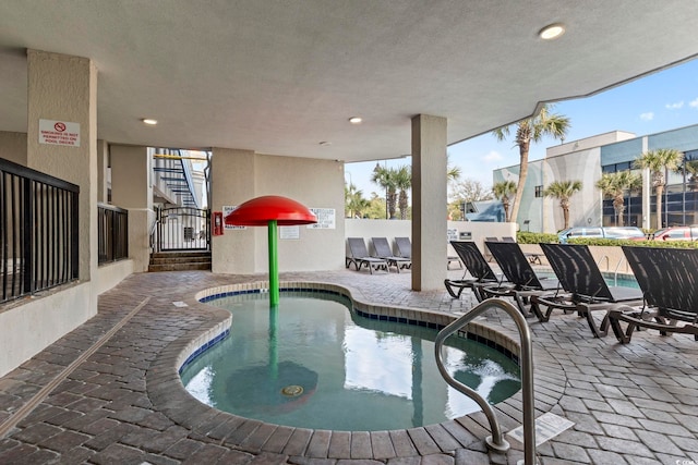 view of swimming pool with an in ground hot tub and a patio